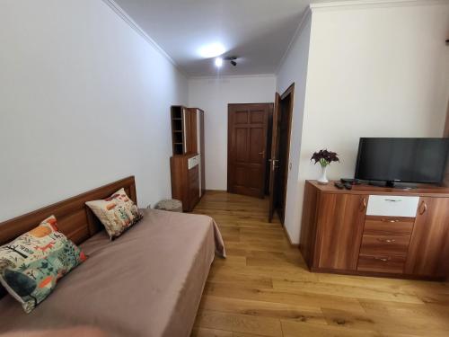 a living room with a couch and a flat screen tv at Senyői Vendégház in Bózsva
