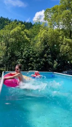 a woman in a pool on a raft in the water at Girskiy Prutets in Bukovel