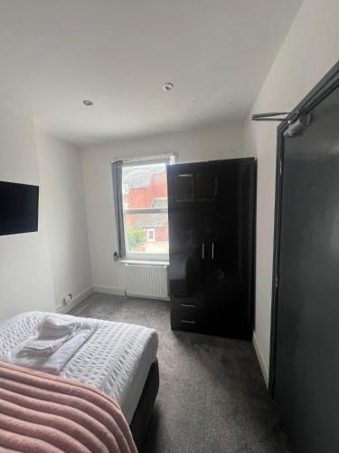 a bedroom with a bed and a window at Town Centre Private Room 3 in Barnstaple