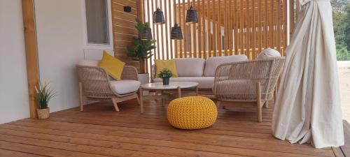 a porch with chairs and a couch and a table at SEA HOUSE mobile home, pool, bikes, SUP - PRIVILEGE POINT camping & villas in Orebić