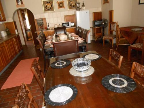 a dining room with a table and chairs at Lizzie's in Potchefstroom