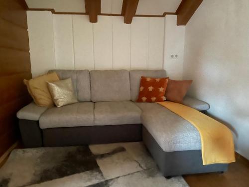 a couch with pillows on it in a room at Haus Karin Mallnitz in Mallnitz