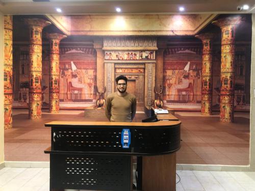 a man sitting at a desk in a museum at Grand Pyramid View Hotel in Cairo
