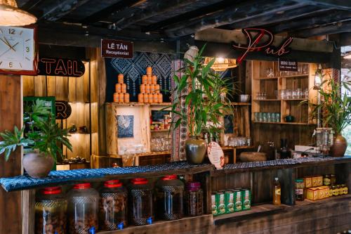 a bar with bottles of alcohol on a shelf at Ha Giang Xanh Retreat - Trekking, Tour, Motorbike Rental in Ha Giang