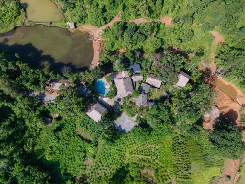 an overhead view of a house in a forest at Ha Giang Xanh Retreat - Trekking, Tour, Motorbike Rental in Ha Giang