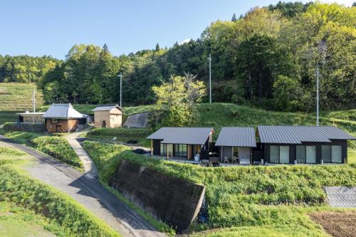 a group of houses on a hill with a road at THE TANADA SAUNA サウナ 露天風呂 棚田一望 Refaシャワードライヤー in Sakai