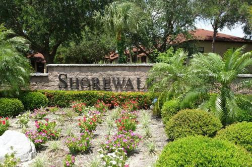 a sign in a garden with flowers and plants at Florida Bella Rosa near IMG Academy & beaches in Bradenton