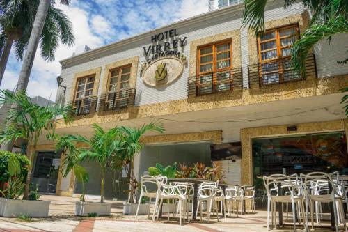 a row of tables and chairs in front of a hotel at Hotel Virrey Cartagena in Cartagena de Indias