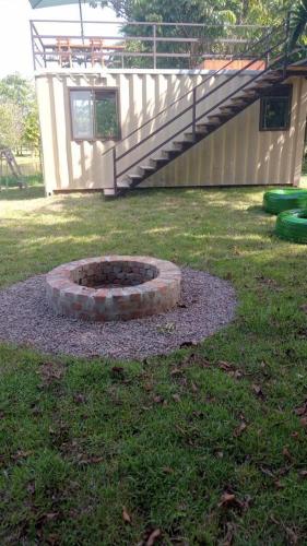 a fire pit in a yard next to a house at Glamping Villas del Llano in Villavicencio
