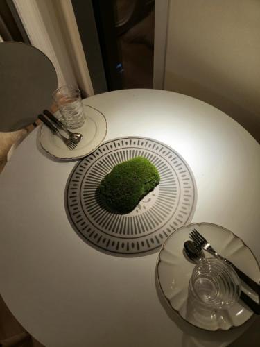 a plate with a green cake on top of a table at Mango&Haru House in Seoul