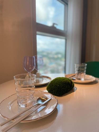 a table with two plates and a glass of water on it at Mango&Haru House in Seoul