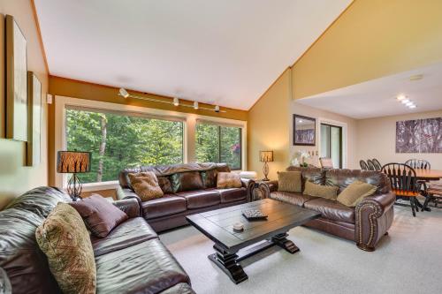 a living room with leather couches and a table at 1 Mi to Loon Mountain Lincoln Haven with Balcony in Lincoln