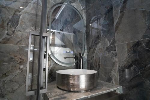 a bathroom with a round sink and a mirror at La Villa Ora in Antibes