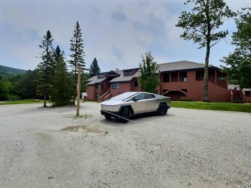 a car is tied to a pole in a driveway at BeaverBox AC, Pool, Hot Tub, Sauna, Near Resort in Killington
