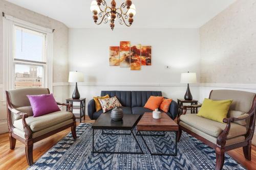 a living room with a couch and two chairs at Charming New England style apartment 6 miles to downtown Boston, 4 miles to Logan airport in Revere