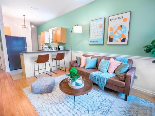 a living room with a couch and a table at Traveler's Dream - Free Parking near Forsyth Park in Savannah