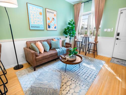 a living room with a couch and a table at Traveler's Dream - Free Parking near Forsyth Park in Savannah