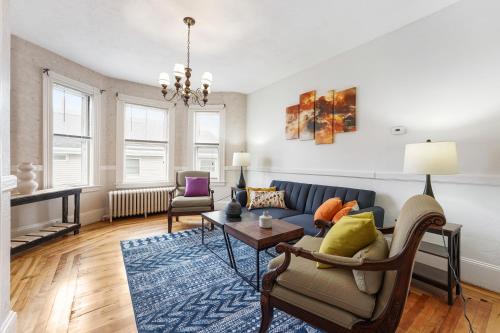 a living room with a couch and a table at Charming New England style apartment 6 miles to downtown Boston, 4 miles to Logan airport in Revere