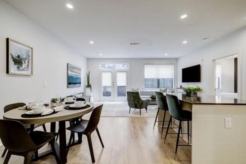 a dining room and living room with a table and chairs at UBP - Brand New Midtown Montrose 1 Bd Apt in Houston