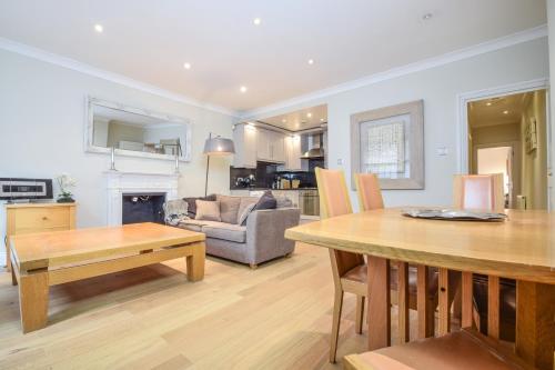 a living room with a table and a couch at Top Properties Chelsea in London