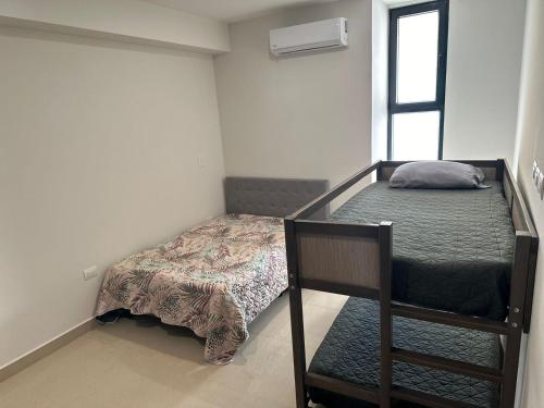 a small bedroom with a bunk bed and a pillow at Increíble depa frente al mar in Mazatlán