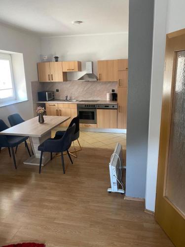a kitchen and dining room with a table and chairs at Apartman MB in Posušje