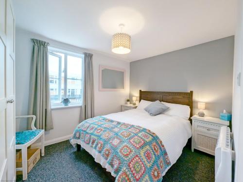 a bedroom with a bed and a window at Steyne by the Sea in Bognor Regis