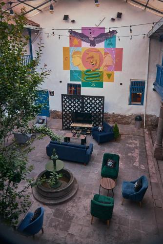 a patio with couches and a table and chairs at Way Kap Hostel Cusco in Cusco