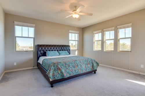 a bedroom with a bed and a ceiling fan at Patio and Balcony Spacious Gilbert Getaway! in Gilbert