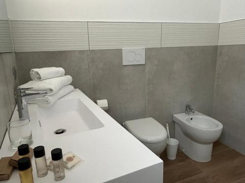 a bathroom with a white sink and a toilet at Vin dell'Olmo in Castagnole Lanze
