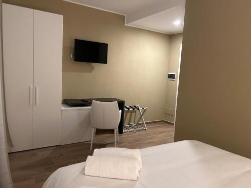 a bedroom with a bed and a table with a chair at Vin dell'Olmo in Castagnole Lanze