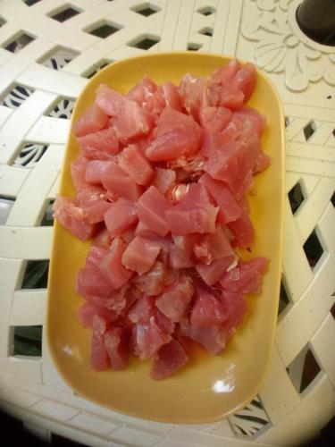 a yellow plate with chopped up ham on it at Hidden Tourist Inn in Abu