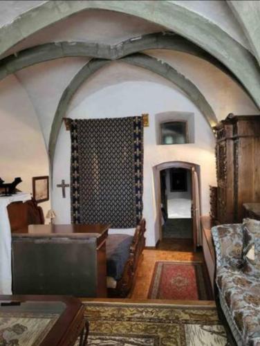 a living room with a bed and a cross on the wall at Burg Hermannstein - Queens Room in Wetzlar