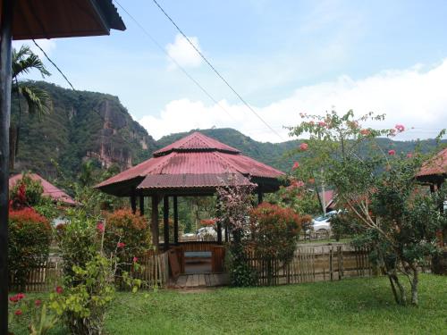 a gazebo in a garden with mountains in the background at Orau Asthana in Arau
