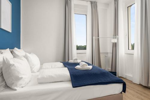 a hotel room with a bed with towels on it at SHINY HOMES - Modern & Cozy Stay in Bielefeld Mitte in Bielefeld