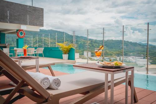 a room with a pool and a table with a plate of food at Holiday Inn Express Yopal by IHG in Yopal