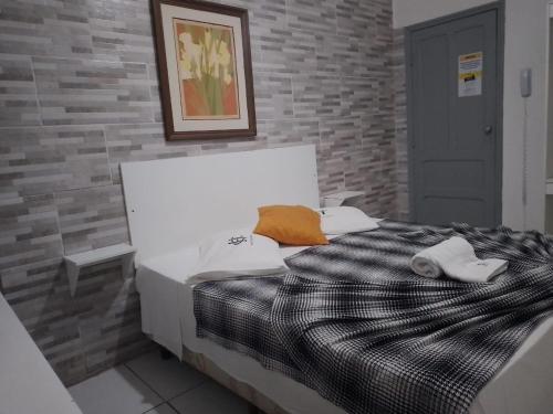 Ένα ή περισσότερα κρεβάτια σε δωμάτιο στο Hotel Centenário