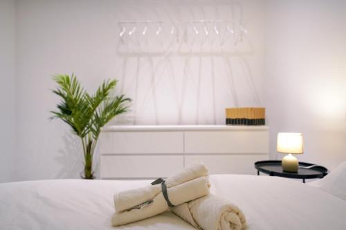 a teddy bear sitting on a bed in a bedroom at Luxury brand new holiday apartments TOP location in Is-Swieqi