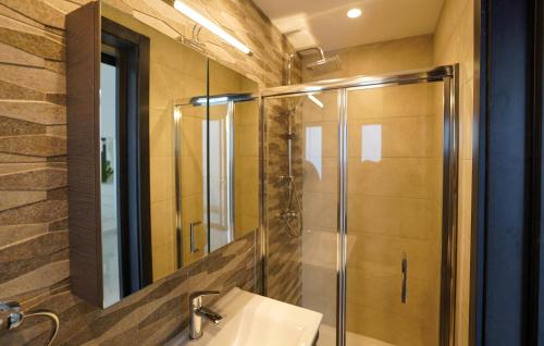 a bathroom with a sink and a shower with a mirror at Luxury brand new holiday apartments TOP location in Is-Swieqi