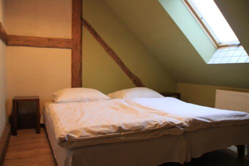 a bed in a room with a window at Dom pod Twierdzą Srebrna Góra in Srebrna Góra