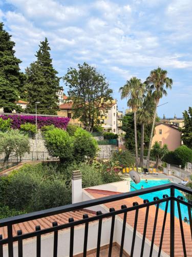 a balcony with a view of a swimming pool at Residence Dei Fiori in Pietra Ligure