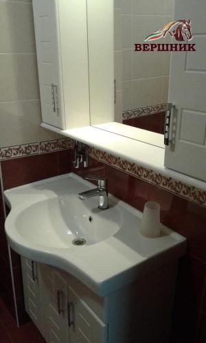 a bathroom with a white sink and a mirror at Vershnyk in Cherkasy