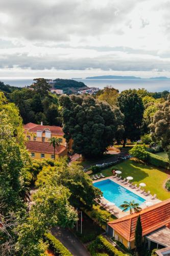an aerial view of a resort with a swimming pool at Casa Velha do Palheiro Relais & Chateaux in Funchal