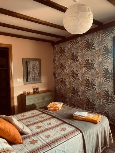 a bedroom with a bed and a wall at CASA RURAL LA CIJA in Maello
