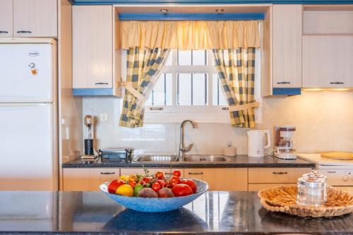 a bowl of fruit on a counter in a kitchen at AQUA Apartment in Koroni