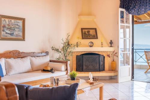 a living room with a couch and a fireplace at AQUA Apartment in Koroni