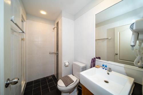 a bathroom with a sink and a toilet and a mirror at Catnip Seaside Hotel&Cafe in Ban Huai Luk (1)