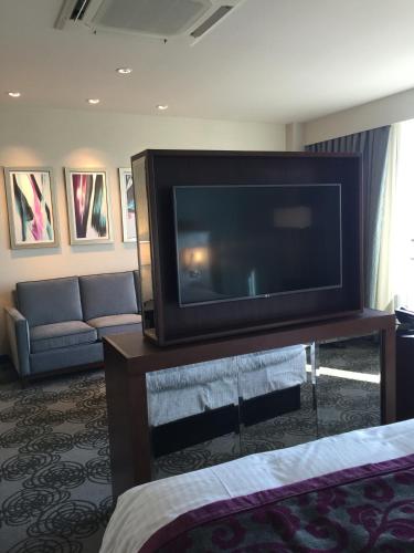 a living room with a large flat screen tv at Parkwest Bicycle Casino in Bell Gardens