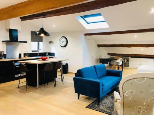 Il comprend une cuisine et un salon avec une chaise bleue et une table. dans l'établissement La Magnanerie, à Montoison