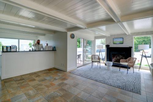 a person standing in a living room with a fireplace at Aspinquid Resort in Ogunquit
